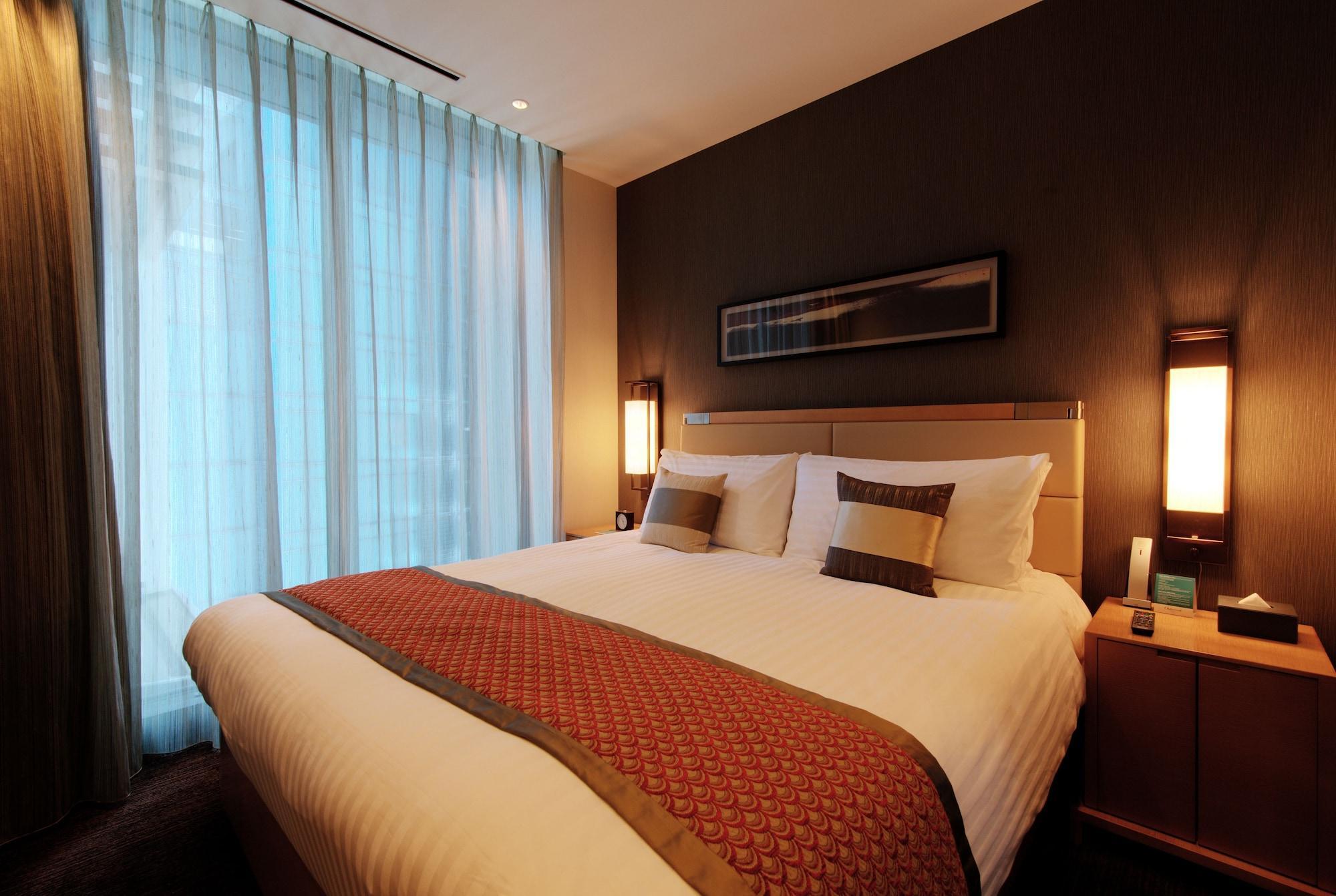 Oakwood Premier Tokyo Hotel Exterior foto A bedroom in a hotel